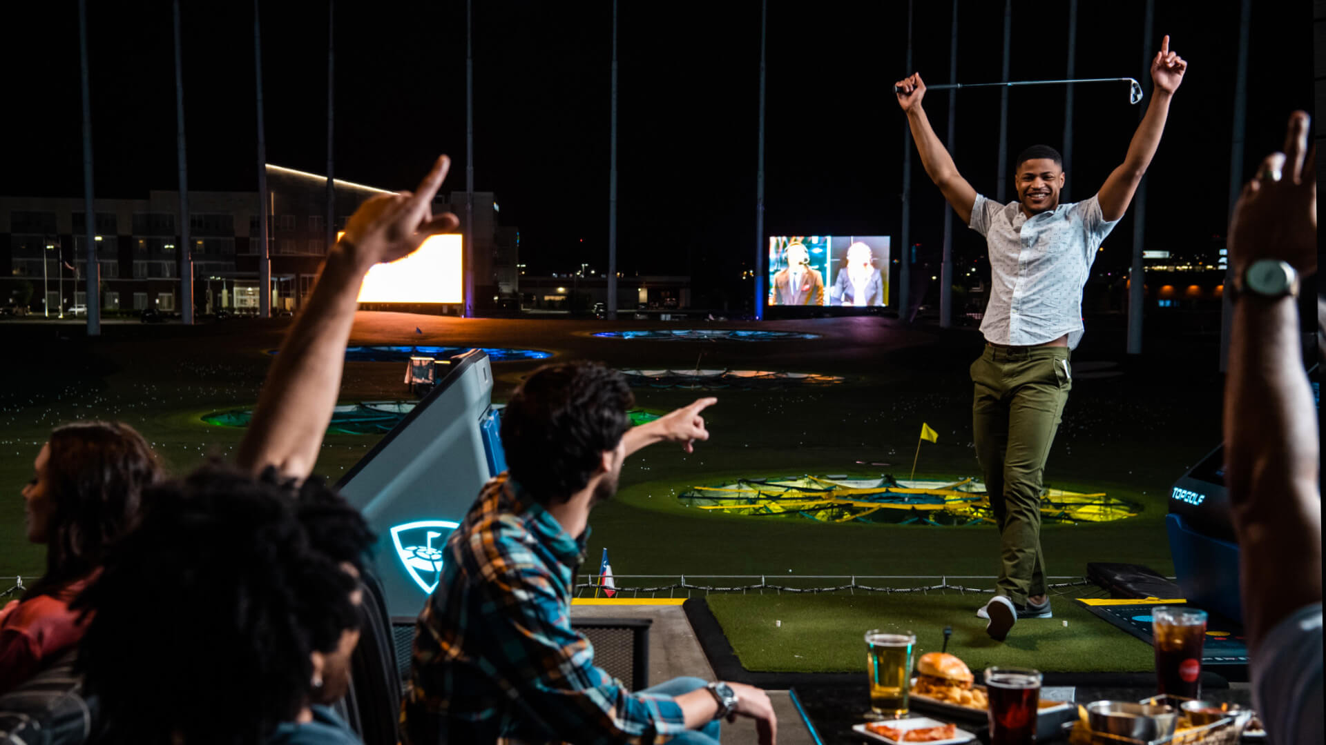 Player celebrating in a bay at Topgolf